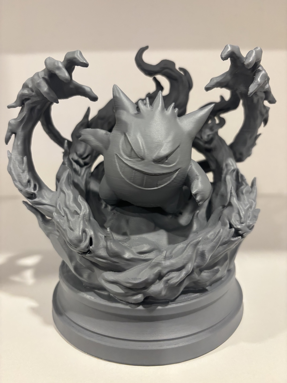 Unpainted character sculpture with swirling sculpted effects